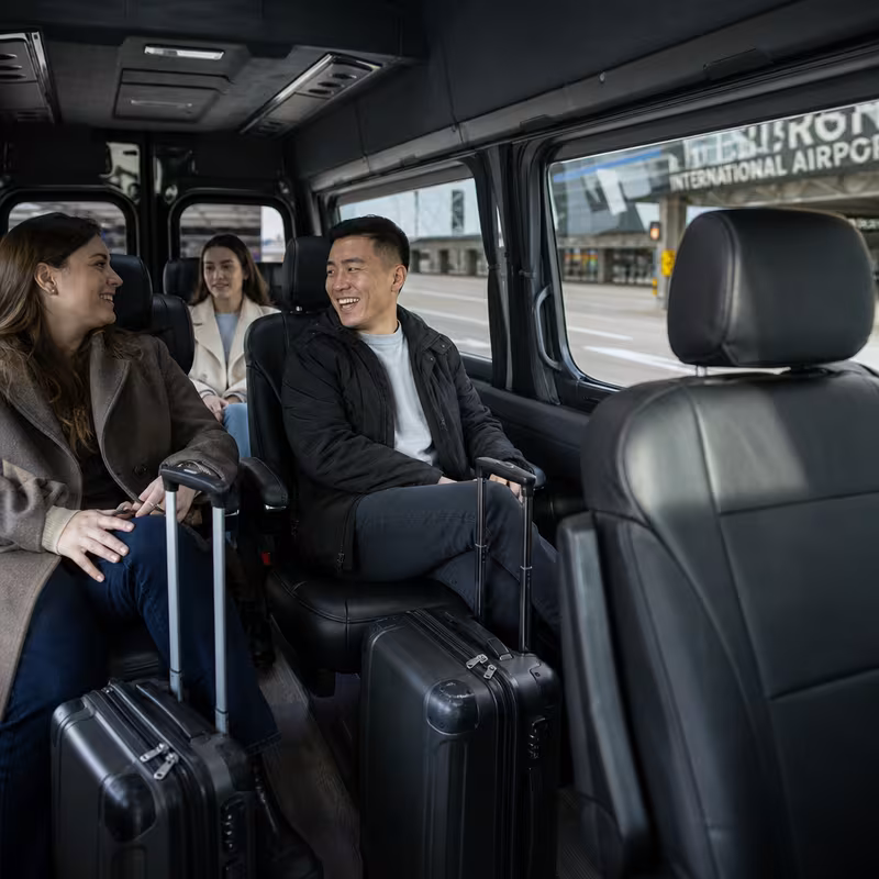 Passengers loading luggage while boarding an Pittsburgh group shuttle