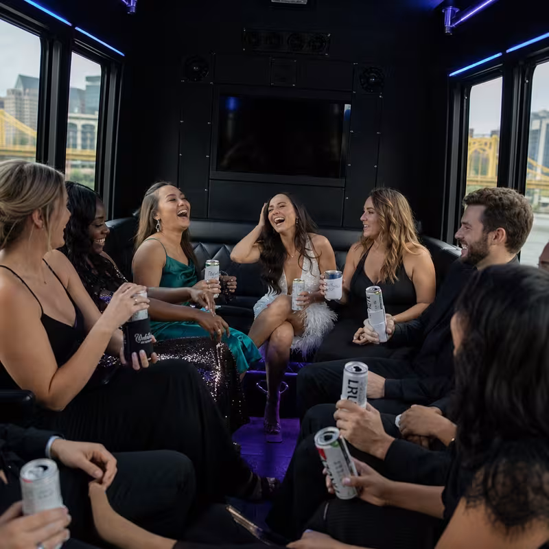 Party bus interior with wraparound leather seating and LED lighting in Pittsburgh