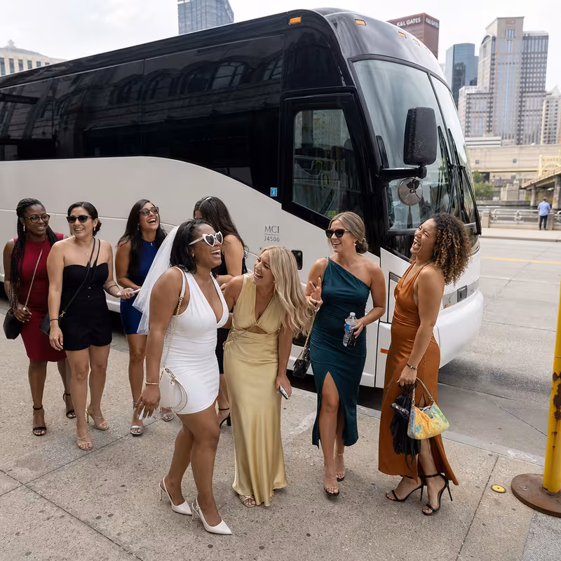 Passengers loading luggage while boarding an Pittsburgh group shuttle