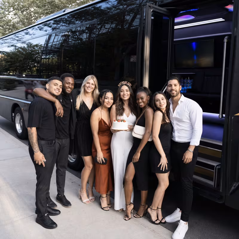 Group boarding a white charter bus for Birthday Transportation transportation in Pittsburgh