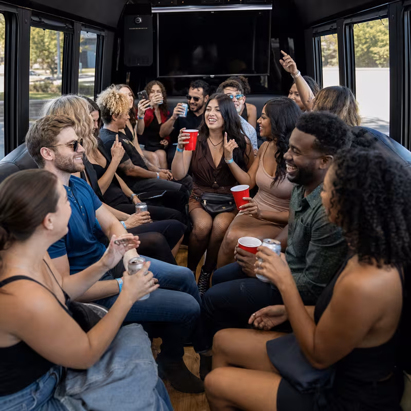 Group boarding a white charter bus for Concert Transportation transportation in Pittsburgh