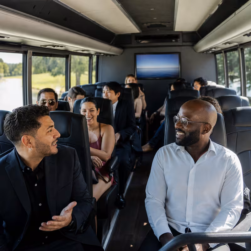 Group boarding a white charter bus for Private Event Transportation transportation in Pittsburgh