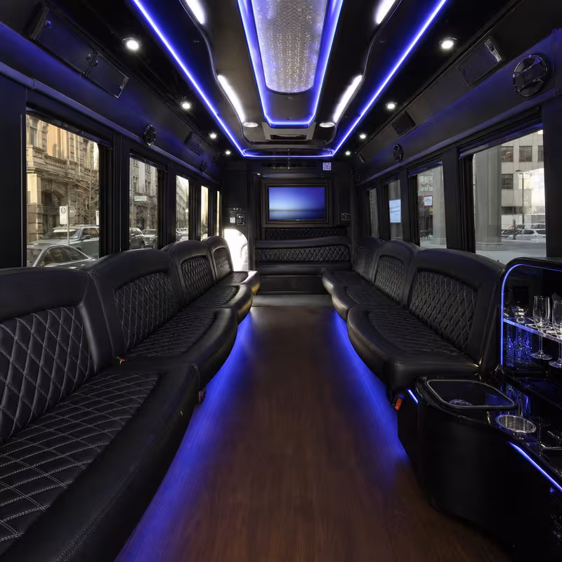 Party bus interior with wraparound leather seating and LED lighting in Pittsburgh