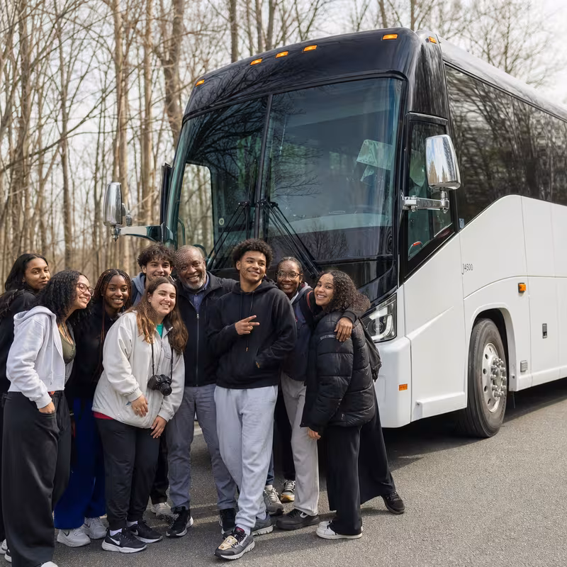 Passengers loading luggage while boarding an Pittsburgh group shuttle