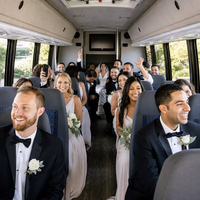 Group boarding a white charter bus for Wedding Transportation transportation in Pittsburgh